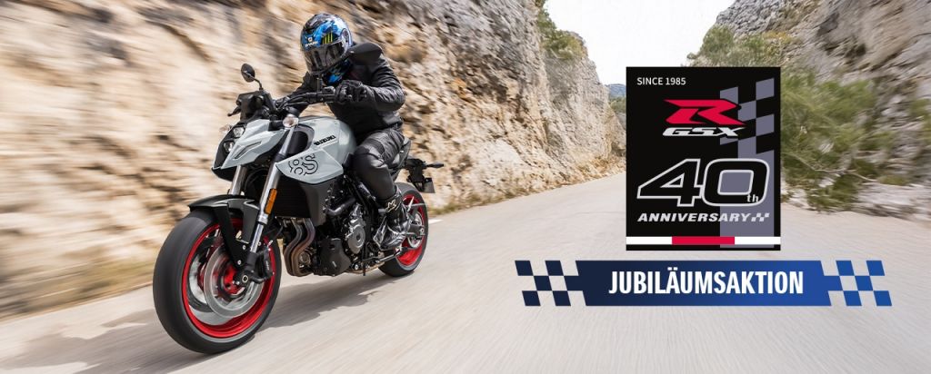Graue GSX-8S auf Bergstraße, rechts unten Jubiläumsaktions-Logo