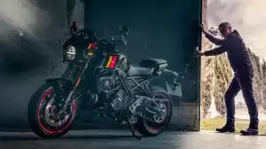 Motorradfahrer in schwarzer Schutzkleidung legt sich mit einer Suzuki GSX-8TT mit roten Felgen dynamisch in eine Kurve auf einer Bergstraße